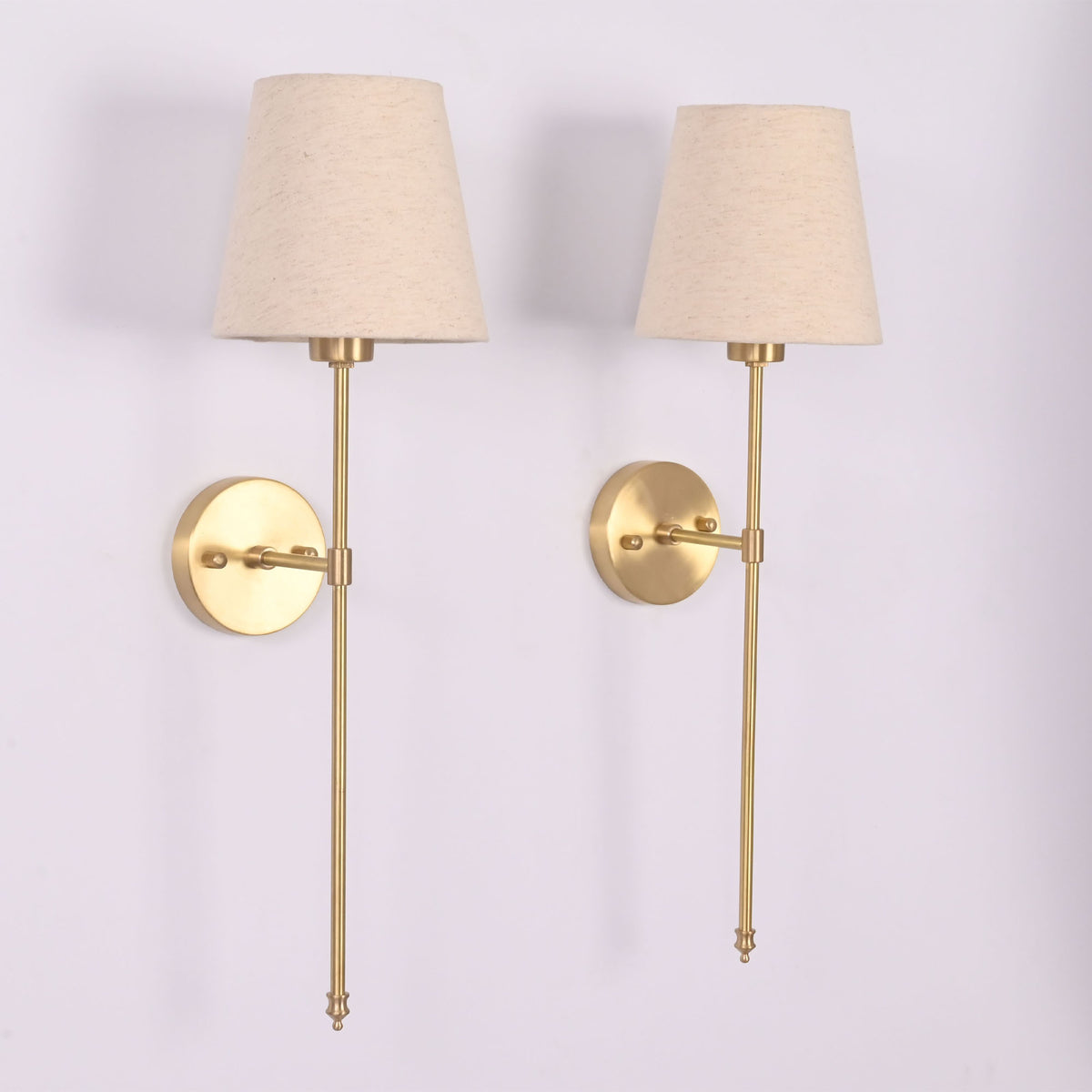 Angled view of Milan cream shade rod wall sconces with tall stems and clean classic design.