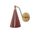 Front product view of the Milan Curved Arm Cone Wall Sconce with a tapered terracotta metal shade, curved brass arm, and round brass wall mount.