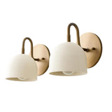 Pair of Milan Dome Wall Sconces featuring handcrafted white dome metal shades, curved solid brass arms, and round wall backplates in a modern Scandinavian design.