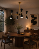 Milan 8 light black and brass double cone chandelier illuminated above a round dining table in a warm Mid-Century Modern dining room.