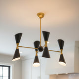 Front view of Milan 8 light double cone chandelier with black shades, warm brass arms and central spherical body.