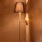 Side angle of navy shade rod wall sconce showing warm lighting effect and elegant wall projection.