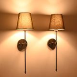 Illuminated olive shade black rod wall sconces creating moody warm light for classic interiors.