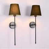 Front view of two olive shade black rod wall sconces with tall stems and clean round plates.