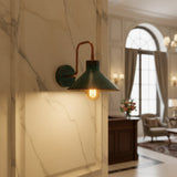 Front view of Milan patina cone wall sconce with warm exposed bulb and curved metal arm – Model 32780