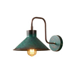 Milan green patina cone wall sconce with curved copper arm and illuminated exposed bulb – Model 32780