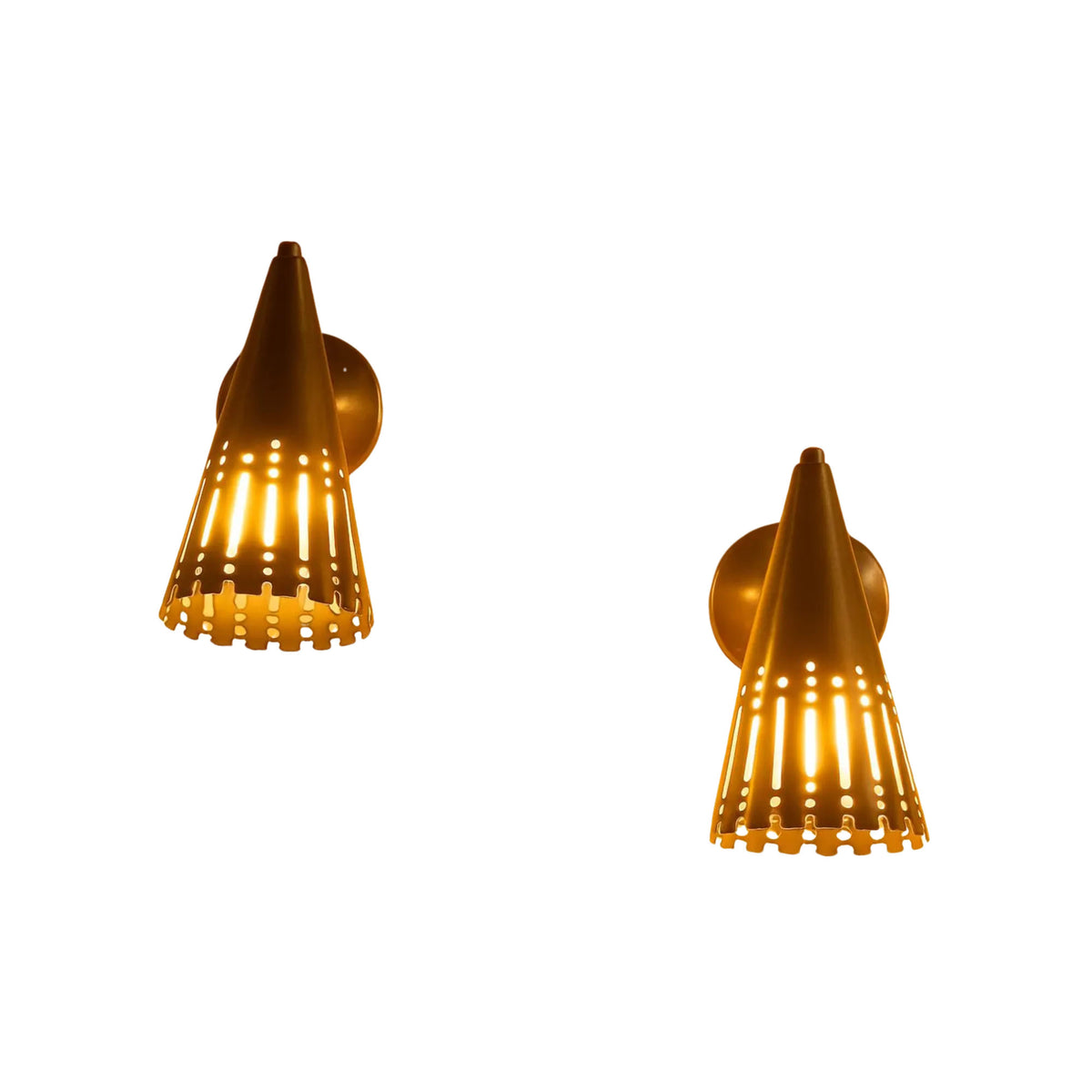 Set of two Milan perforated cone wall sconces illuminated with warm light through decorative shade cutouts.