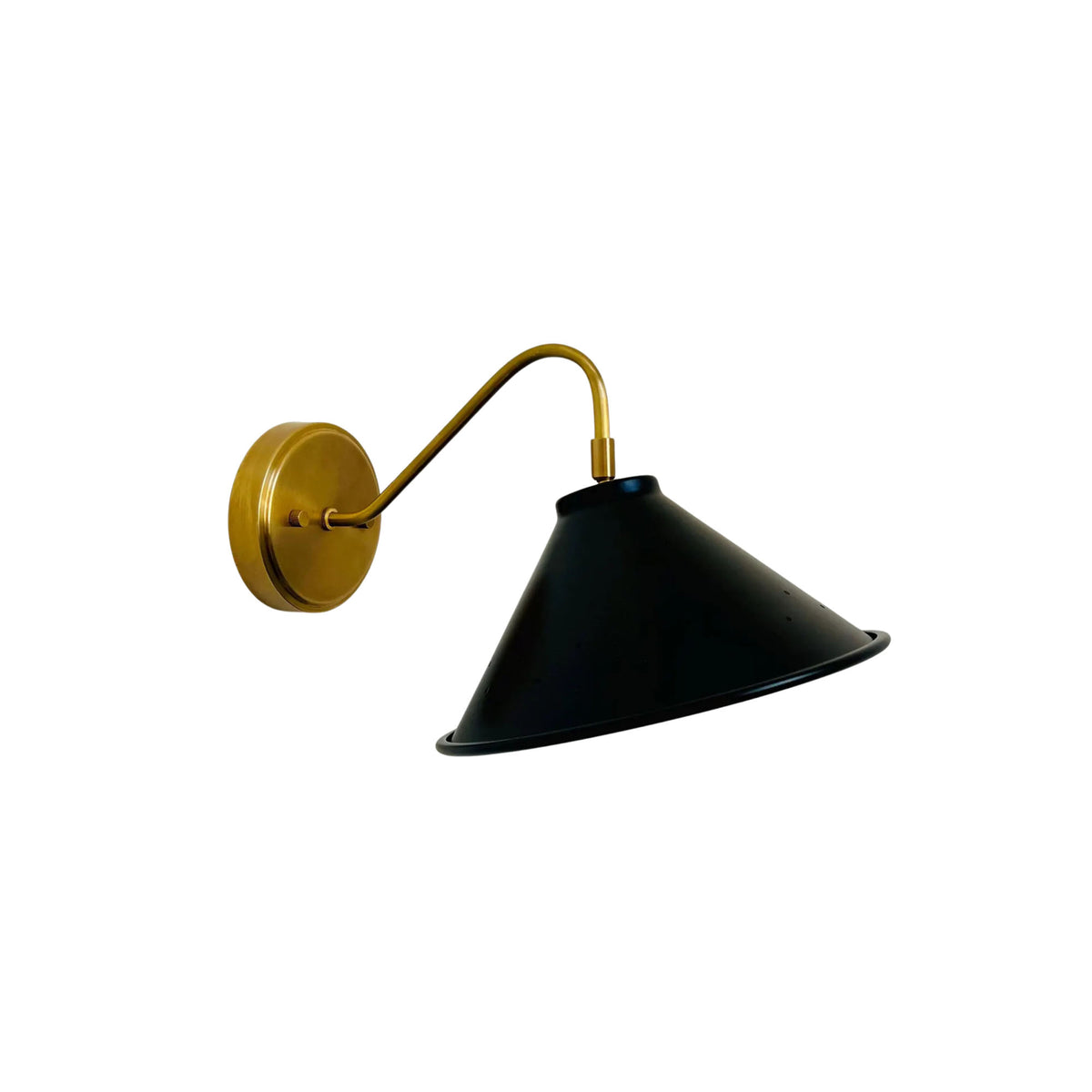 Side angled view of Milan wall sconce featuring a wide black cone shade and curved brass arm.