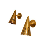 Side view of Milan aged brass wall sconce showing perforated tapered cone shade and round mounting canopy.