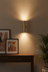 Front view of Milan 10 inch perforated cylinder wall sconce with warm brass finish and round canopy.