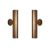 Set of two Milan perforated cylinder wall sconces in warm brass finish with modern vertical design.