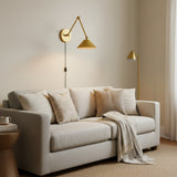 Angled view of Milan brass swing arm wall sconce with pleated cone shade and round wall canopy – Model 32810