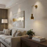 Milan 1 light pulley cylinder wall sconce with suspended metal shade in warm brass finish