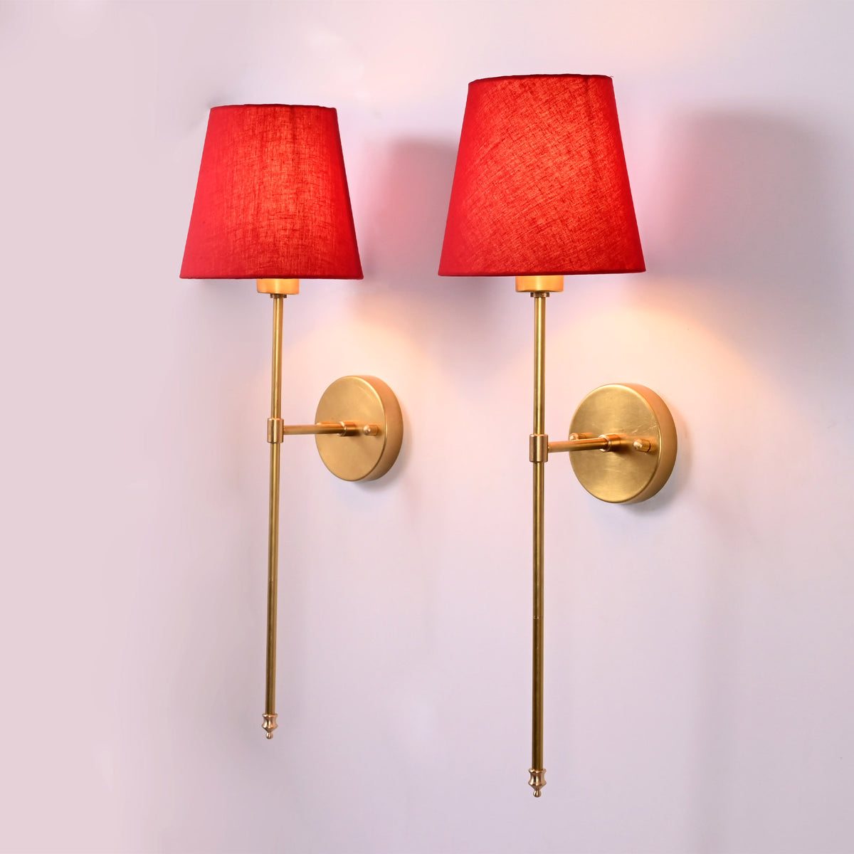 Milan red shade rod wall sconce with tall slim frame, round backplate, and warm ambient glow.