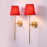 Milan red shade rod wall sconce with tall slim frame, round backplate, and warm ambient glow.