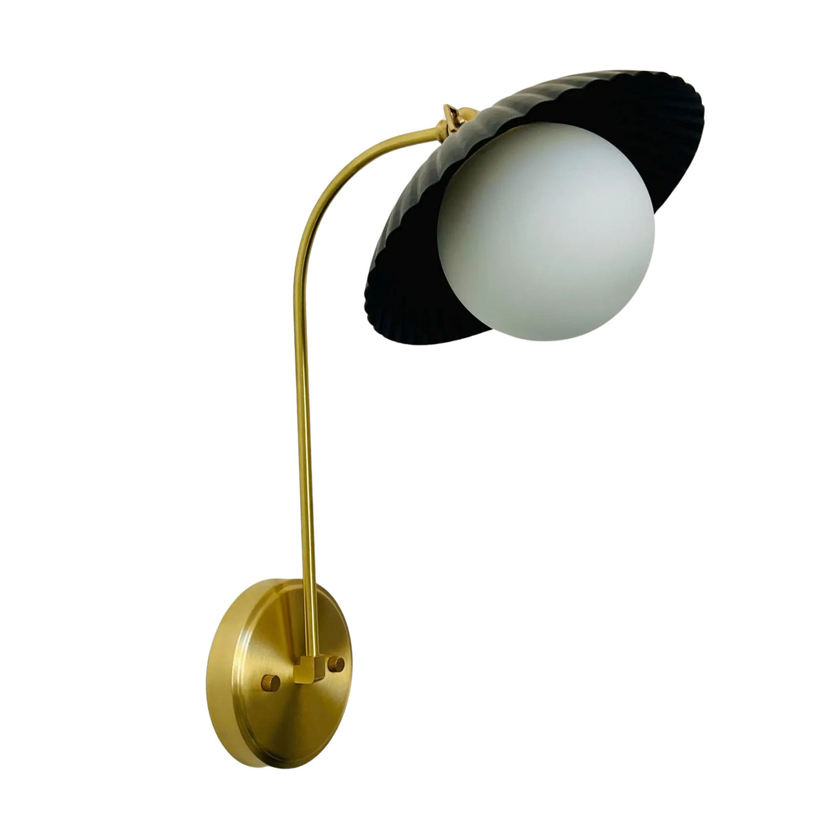 Angled view of Milan wall sconce featuring ribbed black dome shade, frosted glass globe and brass wall mount.