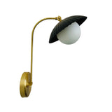 Side profile of Milan ribbed dome wall sconce with frosted globe diffuser and extended brass arm.