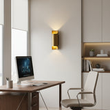 Milan brass up and down wall light illuminated with warm glow, angled view – Model 32807