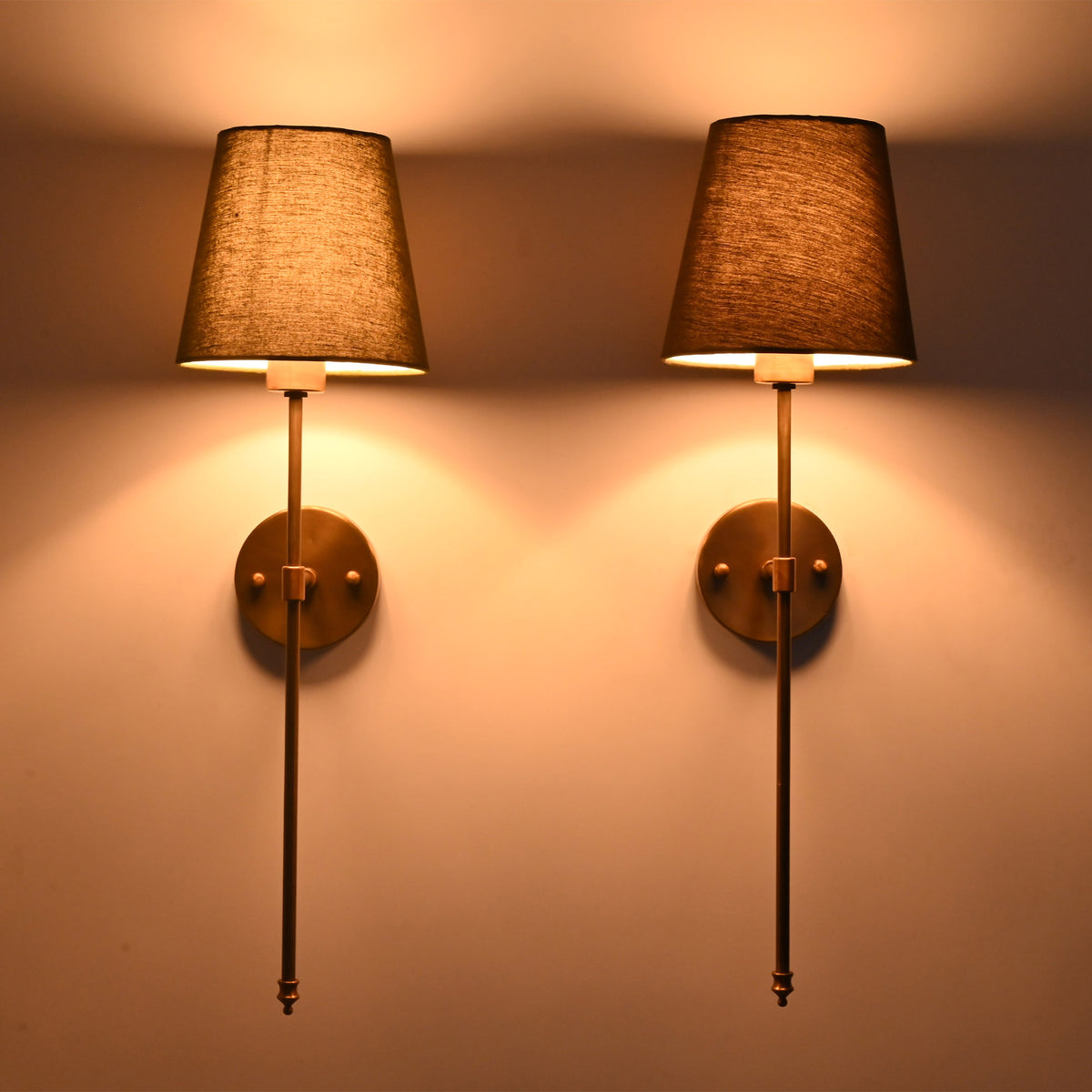 Milan Shade Rod Wall Sconce pair glowing warmly with soft upward and downward wall illumination.