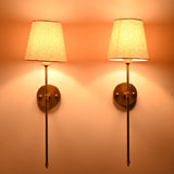 Milan Shade Rod Wall Sconce pair glowing warmly with soft fabric shades and elegant vertical rod design.