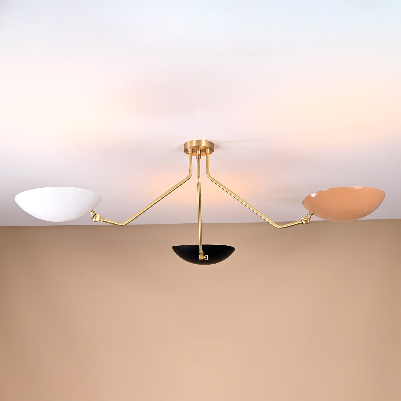 Three-arm brass chandelier with white, black, and beige bowl shades — contemporary flushmount lighting