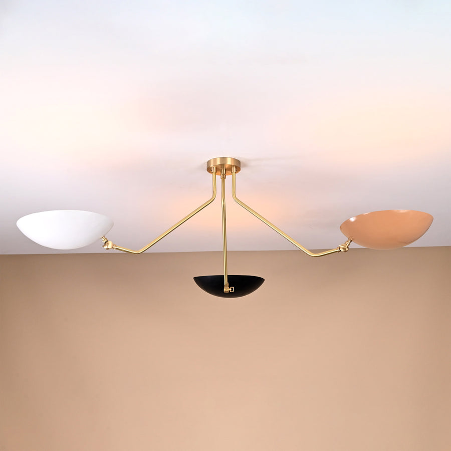 Three-arm brass chandelier with white, black, and beige bowl shades — contemporary flushmount lighting