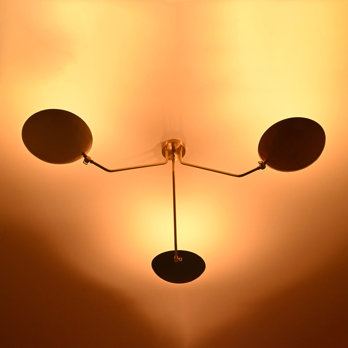 Warm-lit brass ceiling light with bowl reflectors — modern 3-light flushmount chandelier