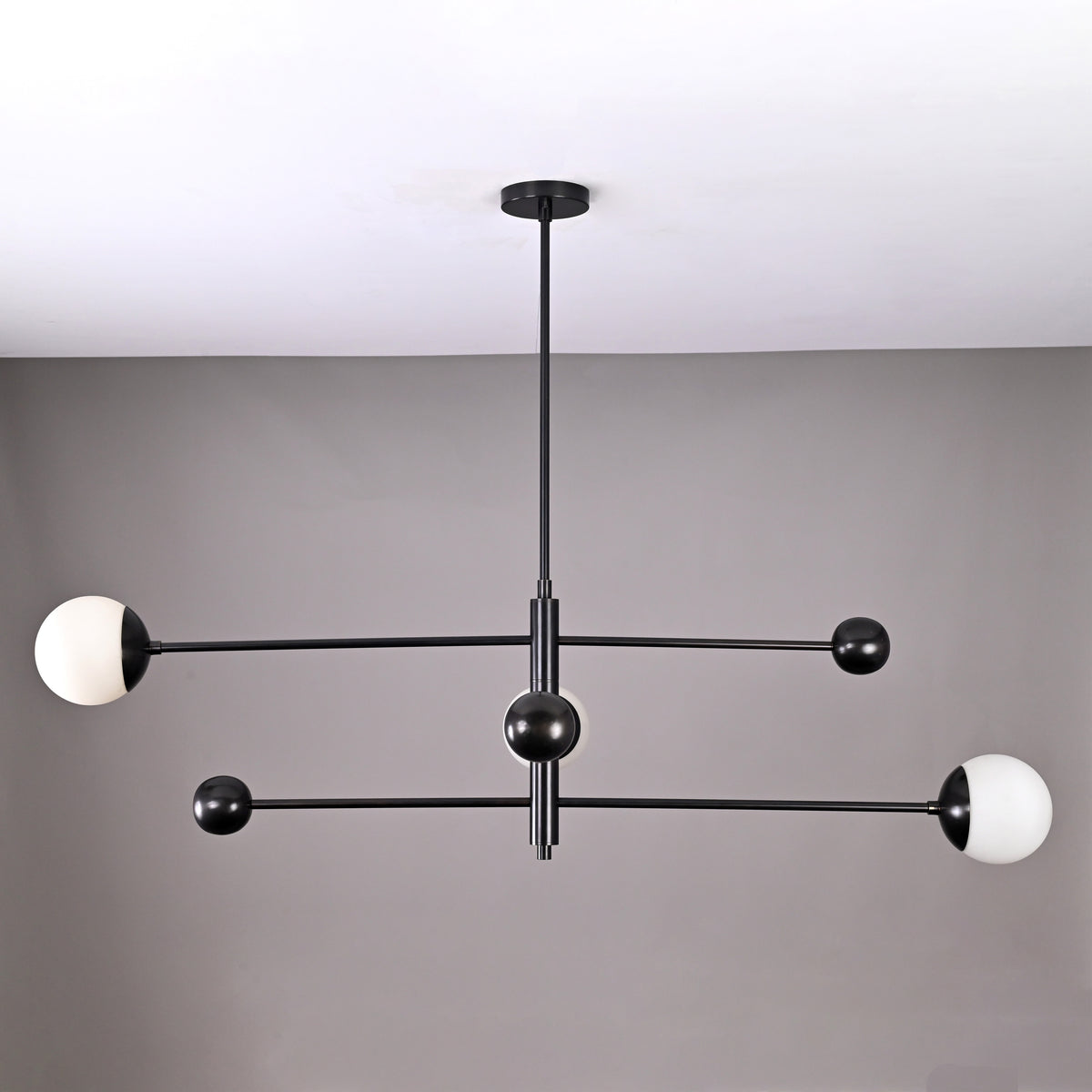 Modern 3-light matte black orb balance chandelier with brass arms – front view