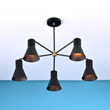 Modern black brass chandelier with five cone-shaped shades, mounted on the ceiling, showcasing bold symmetry and minimalist design.
