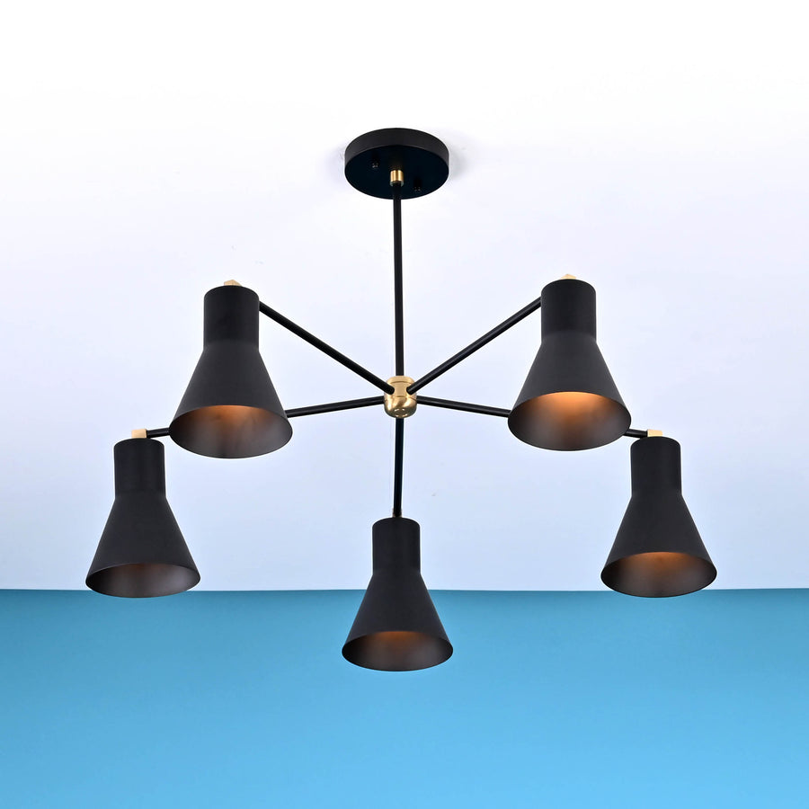 Modern black brass chandelier with five cone-shaped shades, mounted on the ceiling, showcasing bold symmetry and minimalist design.