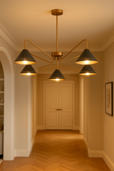Modern black and brass chandelier with bold cone shades, ideal for living rooms and dining spaces.
