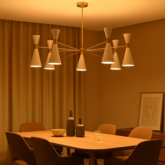 Warm-lit brass chandelier with white dual cone shades hanging above a modern dining table in a cozy ambient setting