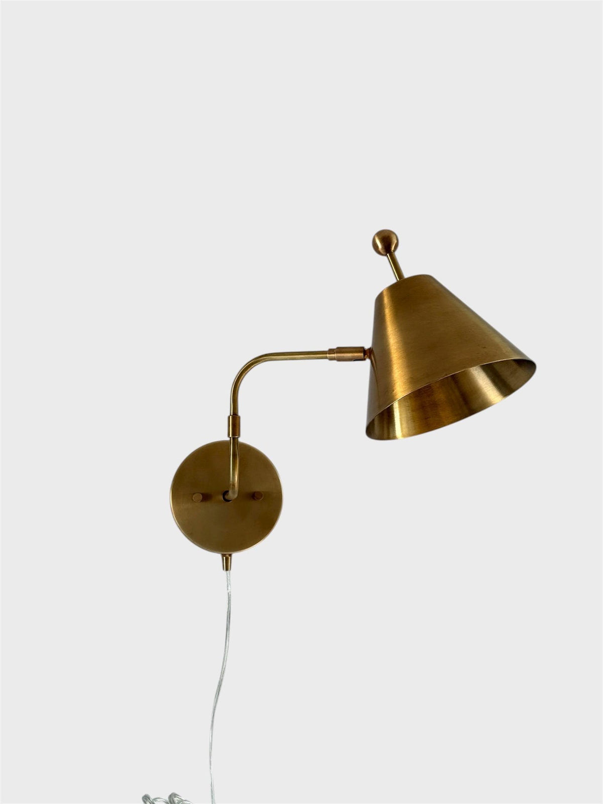Modern Brass Cone Wall Sconce With Plug-In Cord, Brushed Brass Finish, Minimal Adjustable Arm Wall Light On White Background