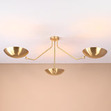 Elegant brushed brass three-arm flushmount ceiling light casting soft ambient glow, handcrafted by Brass Leaf Studio