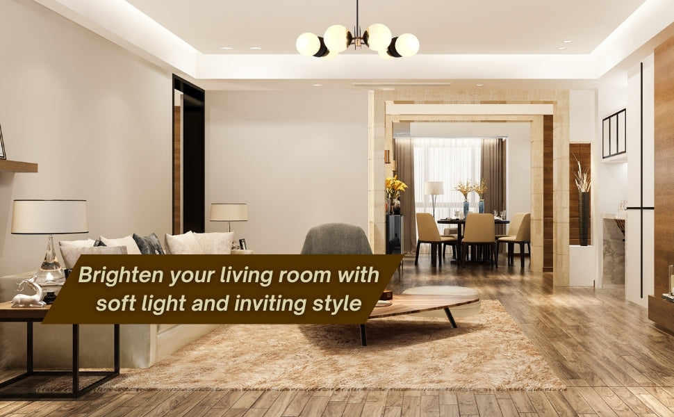 Brass and black globe chandelier lighting up a modern living room with warm inviting tones, styled with neutral furniture and open layout.