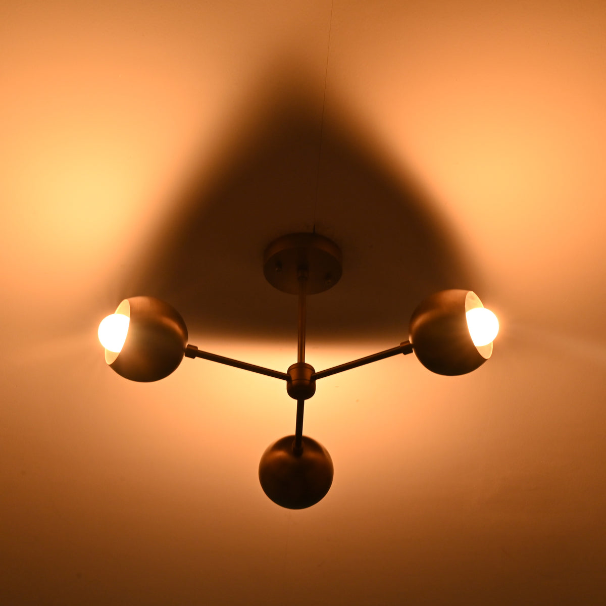 Vintage-style chandelier casting a warm glow on a wall.