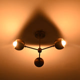 Vintage-style chandelier casting a warm glow on a wall.