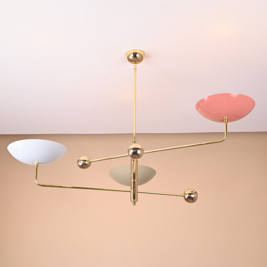 Handmade brass chandelier with colorful bowl shades in white, pink, and green tones, showcasing artistic geometric balance.