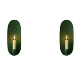 Pair of Monroe modern oval backplate candle wall sconces in a deep green finish featuring elongated oval backplates and candle-style holders.