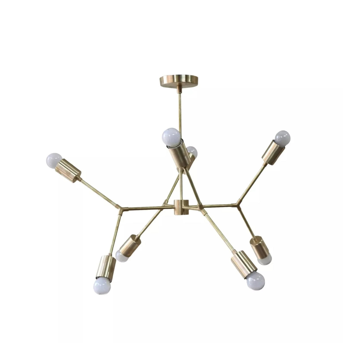 Munich 8 light brass geometric chandelier shown from the side with sculptural branching arms and globe bulbs.