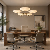 Bottom view of the Munich 5 light chandelier highlighting its branching brass-tone frame and sculptural ivory disc shades.