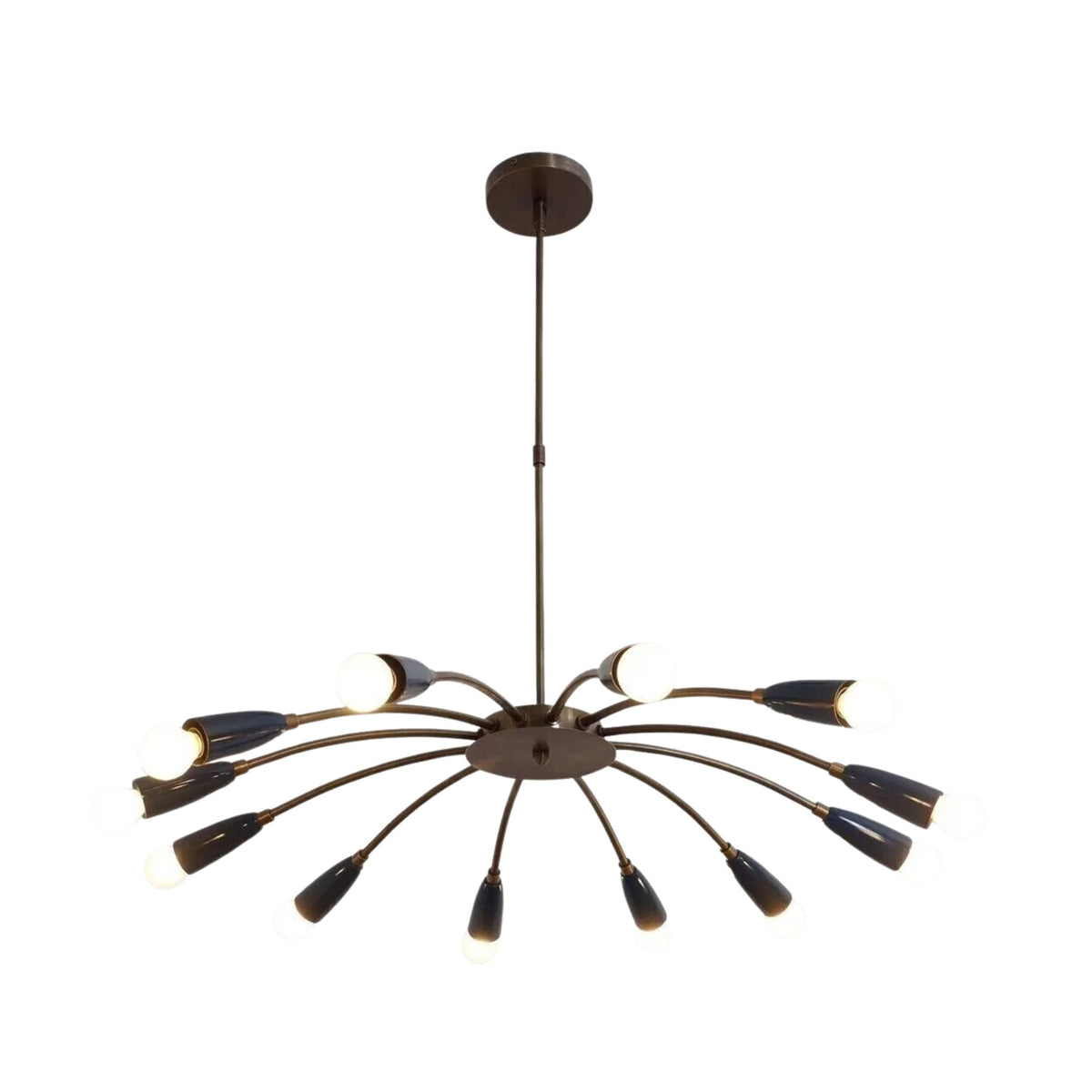 Mykonos 12 light curved arm Sputnik chandelier illuminated in an elegant living room with warm ambient lighting.