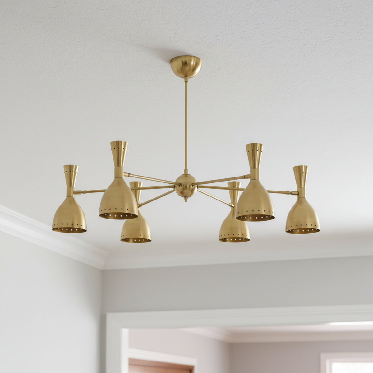 Naples 6 light Mid-Century Modern brass-tone chandelier shown from a straight view with perforated bell-shaped shades.