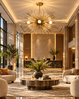 Naples 5-light gold Sputnik chandelier illuminating a sophisticated luxury hotel lobby with marble flooring, cream lounge chairs, a round coffee table, and warm contemporary architectural details.