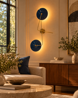 Nashville two-light sculptural wall sconce displayed in a modern living room with a cream sofa, walnut console, and warm ambient lighting.