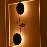 Nashville brass and navy blue wall sconce photographed from an angle with soft warm backlighting and dramatic evening ambiance.