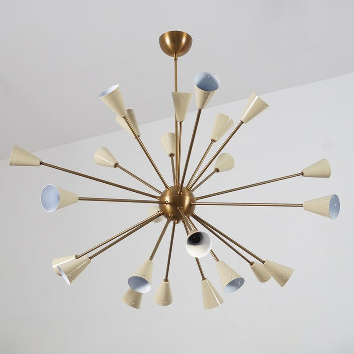 Front view of the Orion 24-Light Mid-Century Sputnik Chandelier featuring handcrafted tapered cone shades, a solid brass frame, and a sculptural starburst design.