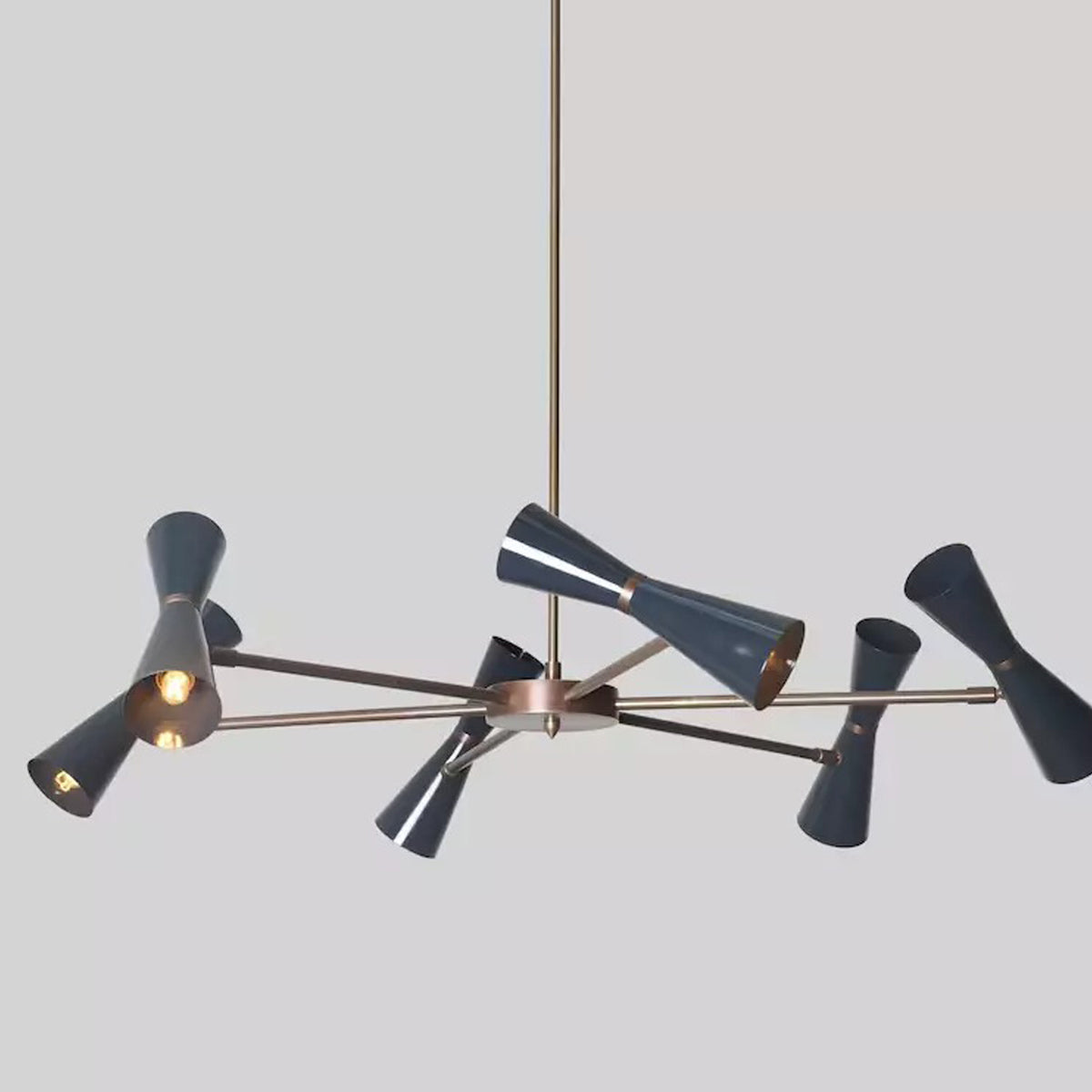Angled view of the Orion 12-Light Double Cone Chandelier showcasing sculptural double cone shades, premium brass construction, and dual-directional lighting.