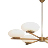 Angled close-up of Orion chandelier showing opal glass shades, brass fittings and sculptural arm design.