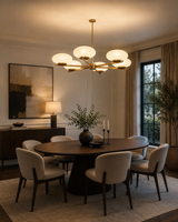 Orion 6 light opal disc chandelier displayed above a modern dining table in an elegant dining room.